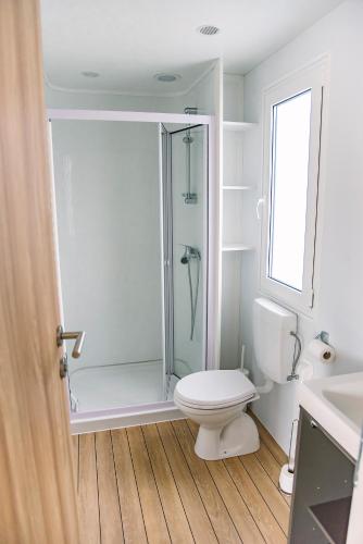 a bathroom with a shower and a toilet and a sink at Vännäs Camping in Vännäs
