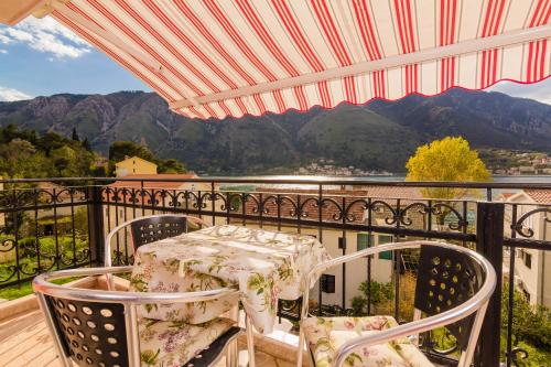 a patio with a table and chairs on a balcony at Apartments Bogdanovic in Kotor