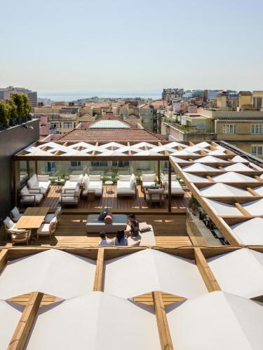 a view from the roof of a building with white umbrellas at Lux Lisboa Park in Lisbon