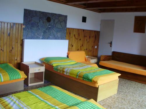 a bedroom with two twin beds and a couch at Sklep u Kunických in Vracov