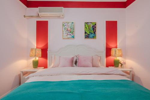 a bedroom with a bed with pink and green at ChengDu JinNiu·ChunXi Road Locals Apartment 00129450 in Chengdu