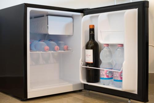 an open refrigerator filled with bottles of wine at B&B AL PASSIO in Palermo