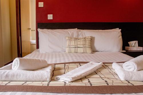a bedroom with a bed with two towels on it at Kings Arms Hotel - A Bespoke Hotel in Kyleakin