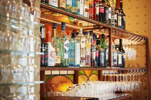 a bar with many bottles of alcohol on shelves at Banks Mansion - All Inclusive Boutique Hotel in Amsterdam