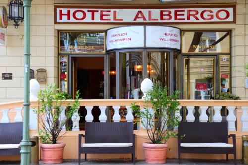 a hotel albergo with two chairs in front of a building at Albergo City Hotel Berlin in Berlin