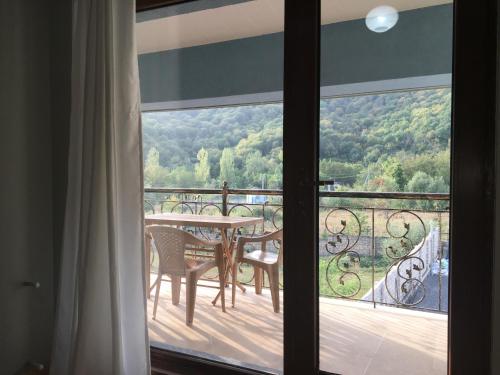 a view of a balcony with a table and chairs at Emerald House Gabala in Gabala