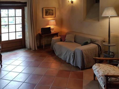 a living room with a couch and a table at Farmhouse in Saint-Cernin with Pool & Views in Saint-Cernin