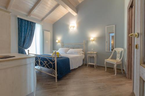 a bedroom with a bed and a table and a chair at Le torri di Tarquinia in Tarquinia