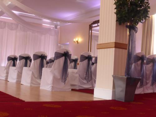 a row of chairs in a room with bows at Glen-Yr-Afon House Hotel in Usk
