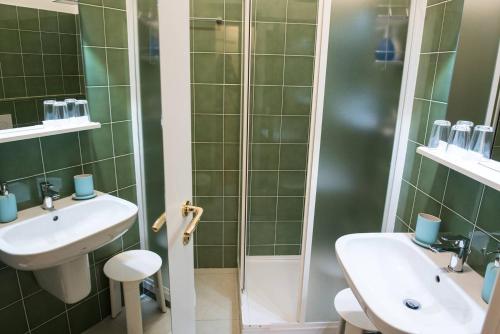 a bathroom with a sink and a shower at Lo Studio - The House Of Travelers in Como