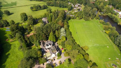an aerial view of a mansion with a tennis court at Glen-Yr-Afon House Hotel in Usk