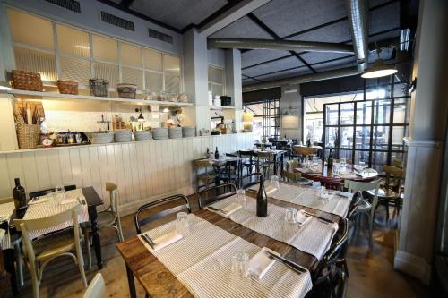 a restaurant with tables and chairs in a room at City Guest House in Rome