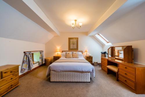 A bed or beds in a room at Glen-Yr-Afon House Hotel