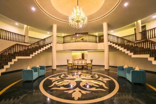 a lobby with a chandelier and a table and chairs at Spectrum Resort, Spa & Residences in Udaipur