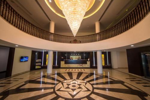 a lobby with a large chandelier and a floor at Spectrum Resort, Spa & Residences in Udaipur