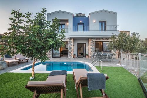 a villa with a swimming pool and a house at Istros Villas, infinite blue, By ThinkVilla in Korakiaí