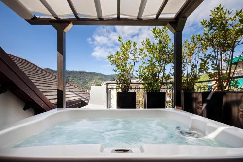 a hot tub on the balcony of a house at LHP Hotel Santa Margherita Palace & SPA in Santa Margherita Ligure