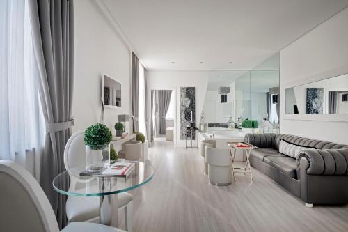 a living room with a couch and a table at LHP Hotel Santa Margherita Palace & SPA in Santa Margherita Ligure