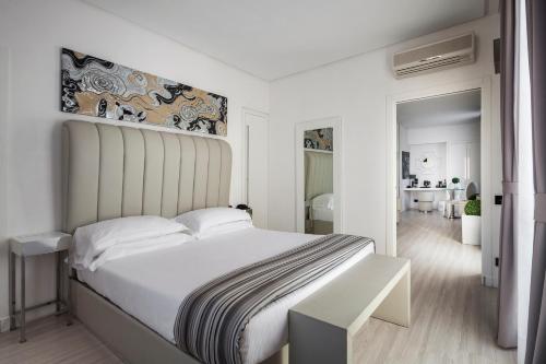 a bedroom with a large white bed with a large headboard at LHP Hotel Santa Margherita Palace & SPA in Santa Margherita Ligure
