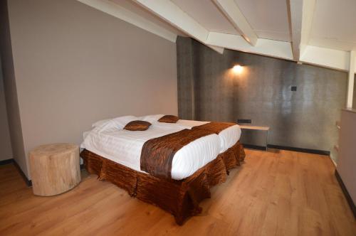 a bedroom with a large bed in a room at Amosa Liège City Centre Hotel in Liège