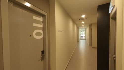 a hallway with a door leading into a building at U Design Hotel Kuala Lipis in Kuala Lipis
