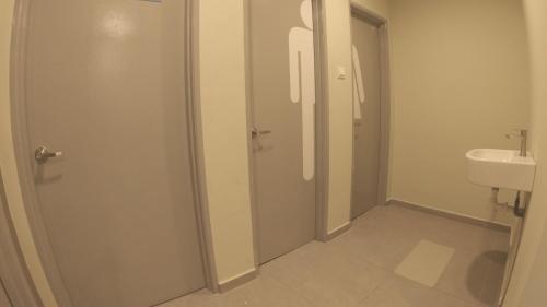 a bathroom with a shower and a toilet and a sink at U Design Hotel Kuala Lipis in Kuala Lipis