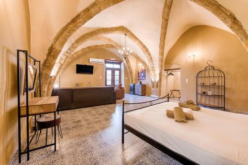 a bedroom with a bed in a room with arches at Knights Of Old Town in Rhodes Town