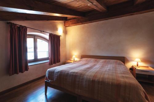 A bed or beds in a room at Residence La Tana del Ghiro