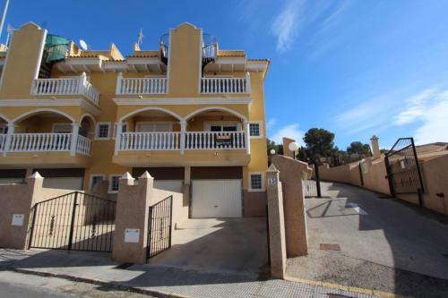 a yellow house with a fence in front of it at Casa Horadada in Algorfa