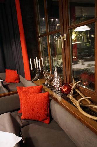 a living room with a couch and a window at Pension Heidi in Kaprun