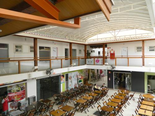 a large room with chairs and tables in a building at Hotel Itu Shopping in Itu