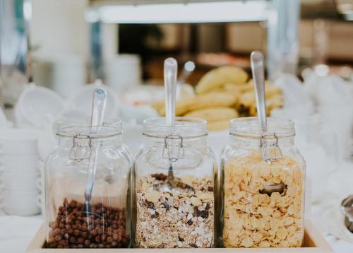 three jars filled with different types of nuts and seeds at Hotel Ivka in Dubrovnik