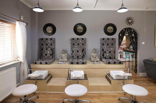 a hair salon with white chairs and mirrors on the wall at Durrant House Hotel in Bideford