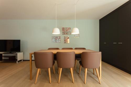 a dining room with a table and chairs at EMA House Serviced Apartments Superior Downtown in Zurich