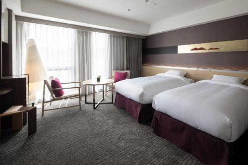 Ένα ή περισσότερα κρεβάτια σε δωμάτιο στο Cross Hotel Kyoto