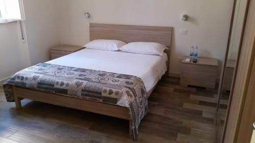 
a bed with a white bedspread and pillows in a room at A Casa di Asia in Grosseto
