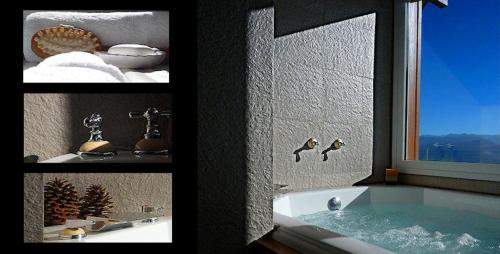 a bath tub in a bathroom with a window at El Nautico Lodge Bariloche in San Carlos de Bariloche