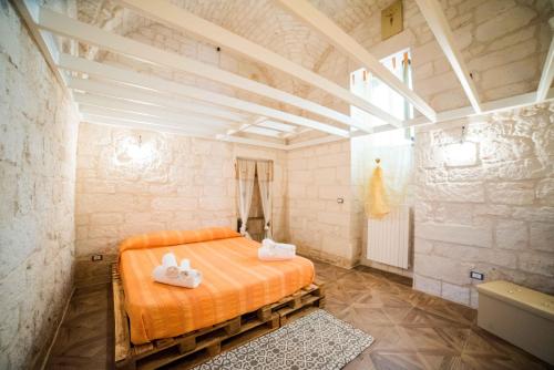 a bedroom with a bed with two white shoes on it at nonna annina in Martina Franca