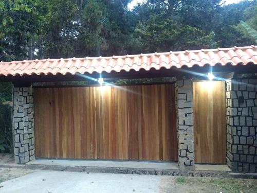 a wooden garage door with lights on it at Eco Chalés Águas Claras in Lumiar