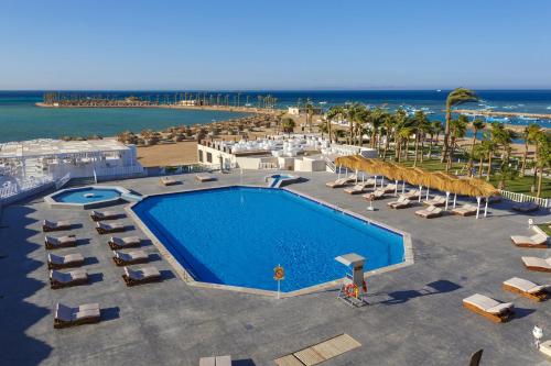 an aerial view of a resort with a swimming pool and the ocean at Meraki Resort - Adults Only in Hurghada