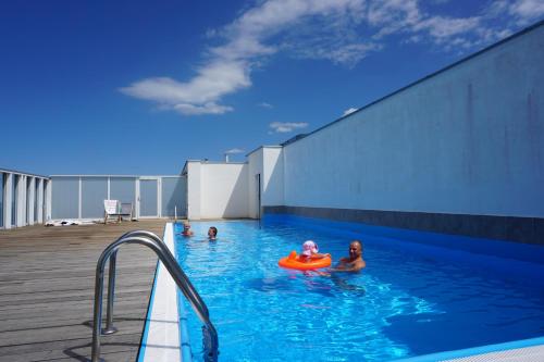 a group of people in a swimming pool at Wechta E5 in Międzyzdroje