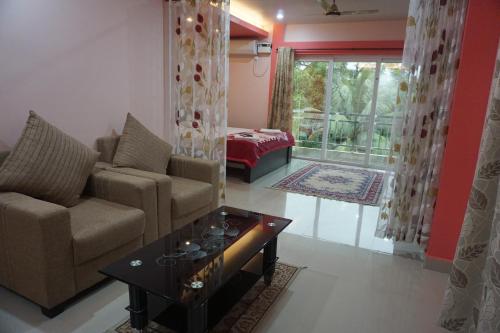 a living room with a couch and a table at The Seaview Residency in Port Blair