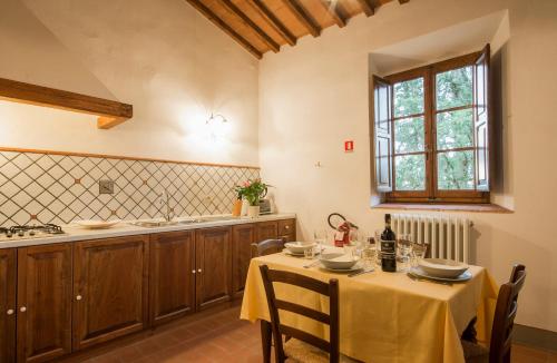 een keuken met een tafel met een geel tafelkleed bij Borgo Bottaia in Grassina