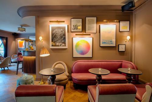 a waiting room with chairs and tables and pictures on the wall at Mondrian Suites Berlin am Checkpoint Charlie in Berlin