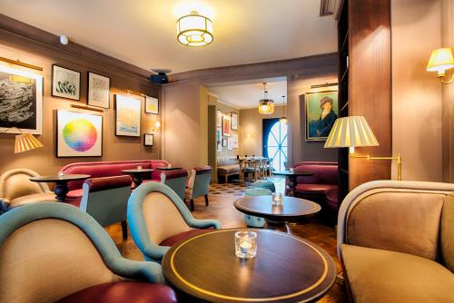a bar with tables and chairs in a room at Mondrian Suites Berlin am Checkpoint Charlie in Berlin