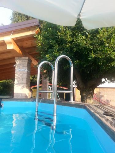 a swimming pool with two faucets in the water at Su Misura in Molini