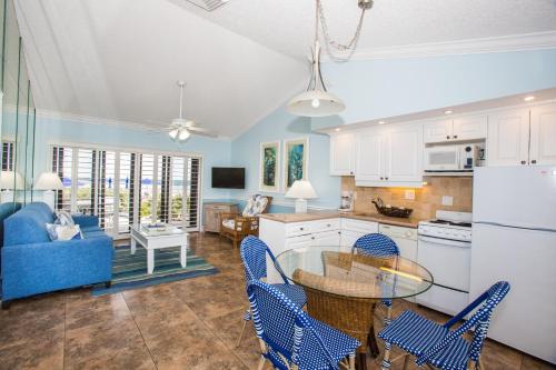 a kitchen and living room with a table and chairs at Jupiter Reef Club Resort in Jupiter