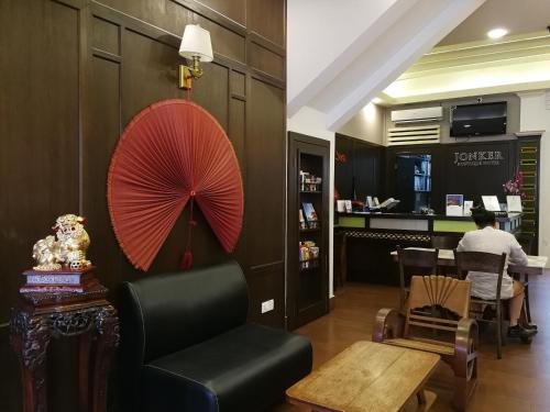 a room with a chair and an umbrella and a table at Jonker Boutique Hotel in Malacca
