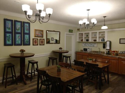 a restaurant with tables and chairs and a kitchen at Thayers Inn in Littleton