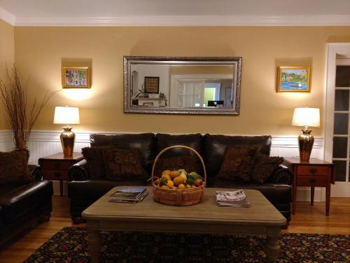 
a living room with a couch and a coffee table at Thayers Inn in Littleton
